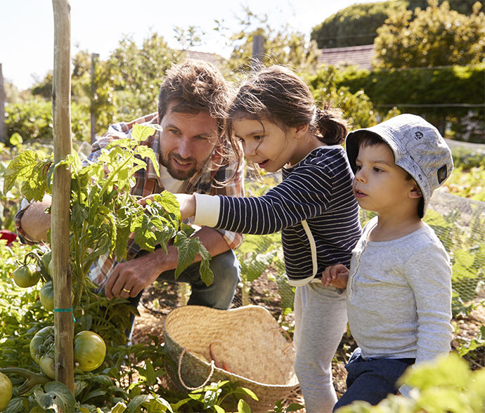 father and daughters in the garden