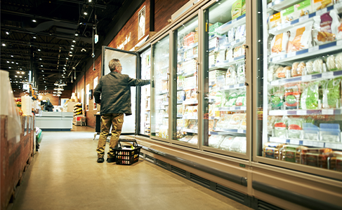 man in freezer section food store