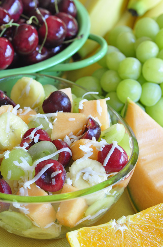 fruit salad with cherries, grapes, melons, and flaked coconut