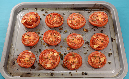 Roasted Tomatoes with Herbs on a baking sheet