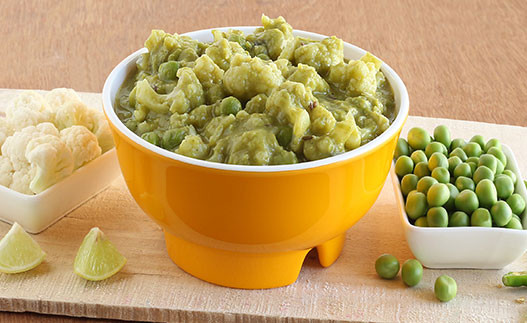 Microwave Cauliflower and Peas in Cream Sauce in a bowl