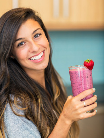 young woman holding smoothie