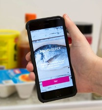 image of a cell phone in a person's hand showing the food keeper app on the screen