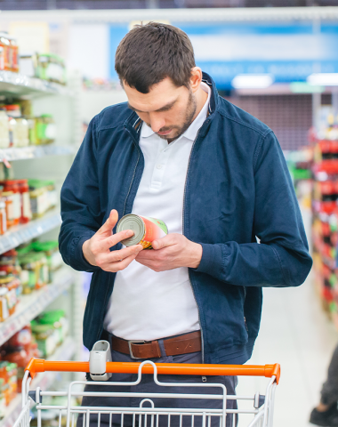 white male grocery store reading can label