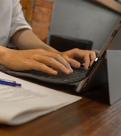 zoomed image of mans hands typing on keyboard