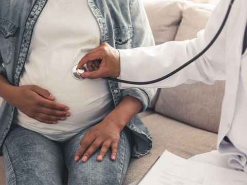 doctor checking pregnant woman