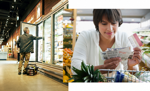 older man in freezer section of store and woman reading grocery coupons