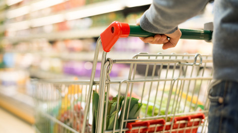 Shopping cart being pushed through grocery store