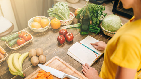 image of a woman following a recipe at her countertop