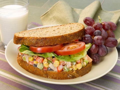 Shrimp Confetti Salad Sandwich with Grapes on a plate