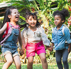 3 young girls outside playing