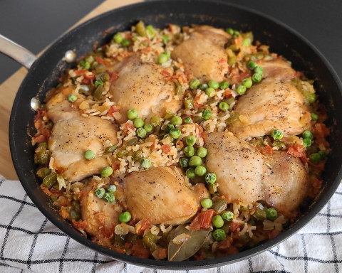 skinless chicken pieces with vegetables in a skillet