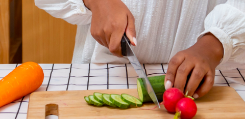 Chef cutting a cucumber