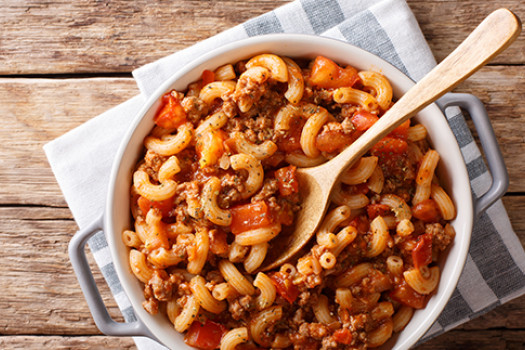 Beefy Macaroni and cheese in a bowl with a spoon