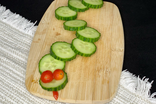 Vegetable Snake on a wooden cutting board