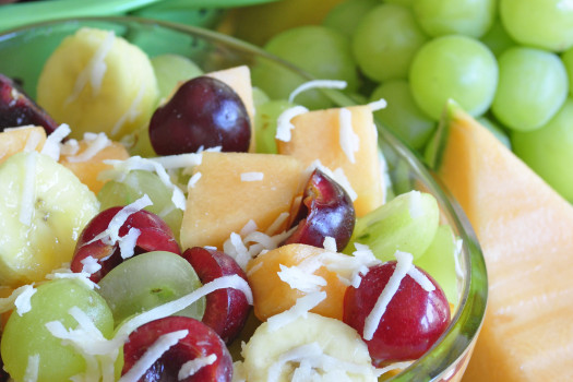 fruit salad with cherries, grapes, melons, and flaked coconut