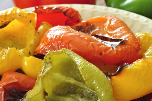 Red, yellow, and green roasted peppers on a plate