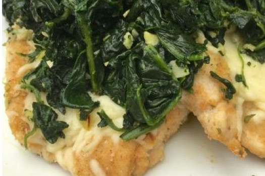 Mozzarella Chicken with Garlic Spinach on a plate