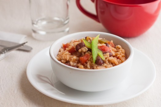 Small bowl of beans and rice with a green bell pepper ganish