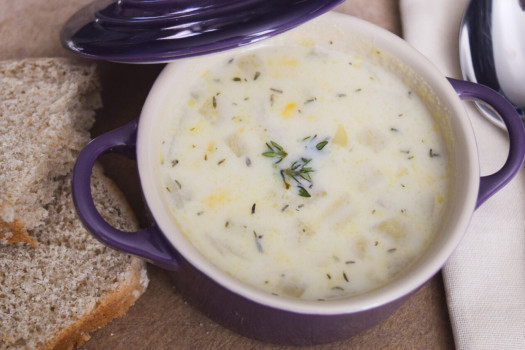 Bowl of Ten Minute Corn Chowder with whole grain bread on the side