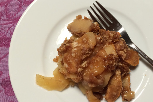 serving of apple crisp on a plate with a fork