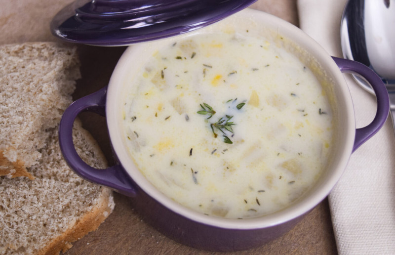 Bowl of Ten Minute Corn Chowder with whole grain bread on the side
