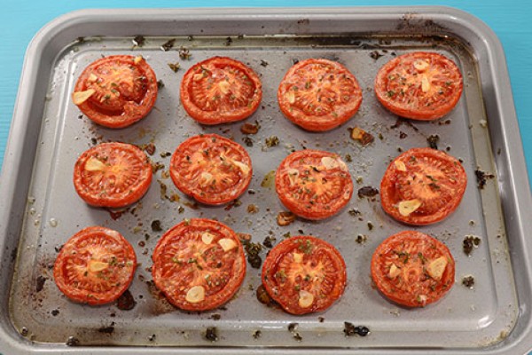 Roasted Tomatoes with Herbs on a baking sheet