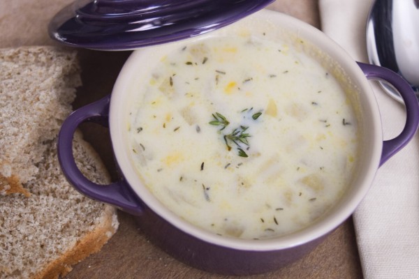 Bowl of Ten Minute Corn Chowder with whole grain bread on the side
