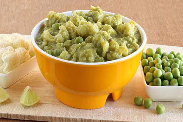 Microwave Cauliflower and Peas in Cream Sauce in a bowl